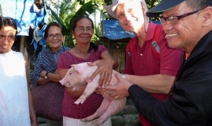 Presenting the pigs  to start a livelihood project