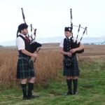 Two lone pipers on Remembrance Sunday on Mull